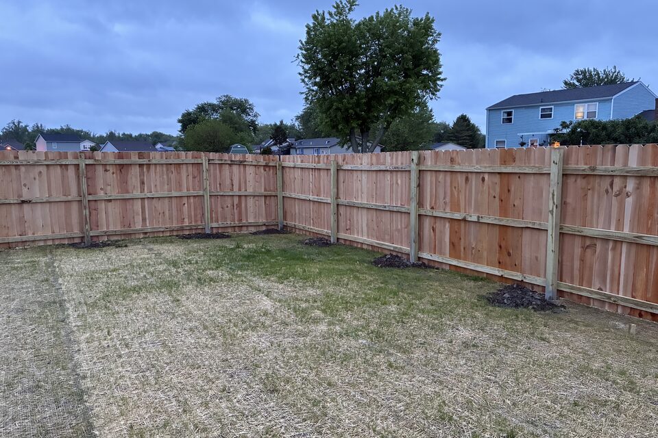 Wood backyard privacy fence across a corner lot